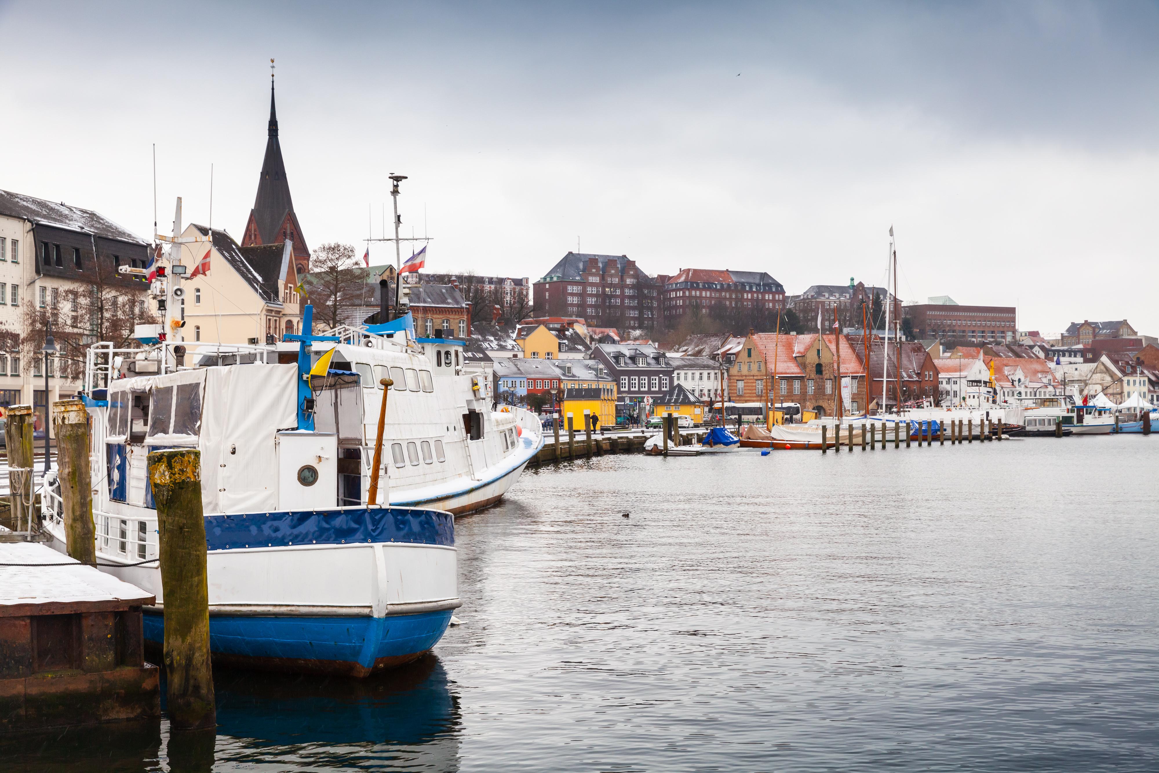 Flensborg havnefront med både i vandet og farverige huse på land 